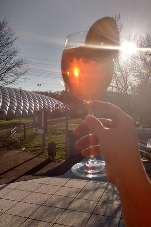 Ein Glas kühler Aperol Sprizz mit Eis und Orangenscheibe auf der Terasse des Sportparks